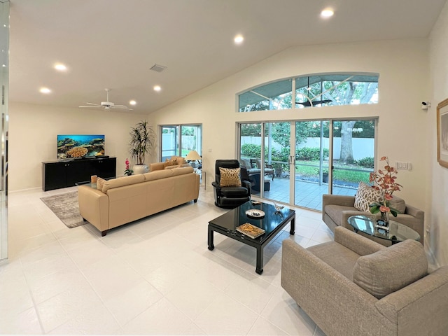 living room with ceiling fan, lofted ceiling, and light tile patterned floors