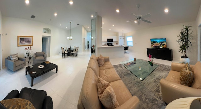 living room featuring lofted ceiling and ceiling fan with notable chandelier