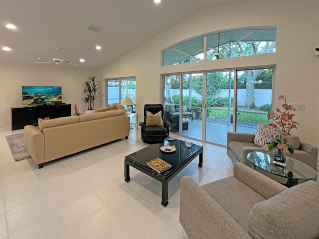 tiled living room with ceiling fan and vaulted ceiling