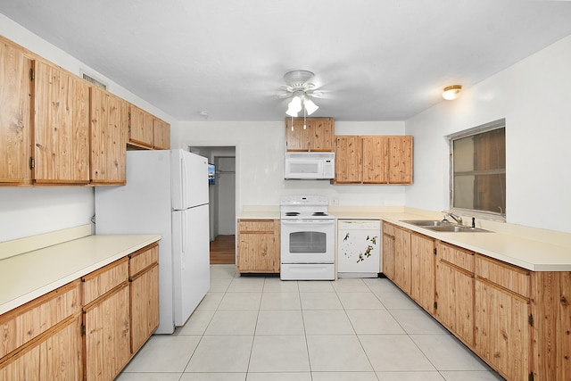 kitchen with white appliances, sink, and light tile patterned floors