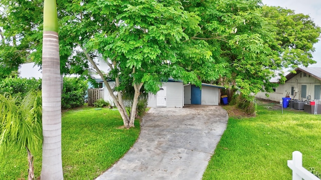 obstructed view of property with a front lawn