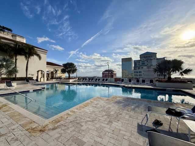 view of community with an outdoor fire pit and a patio