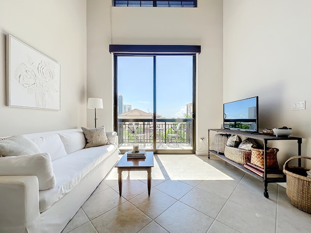 tiled living room featuring a high ceiling