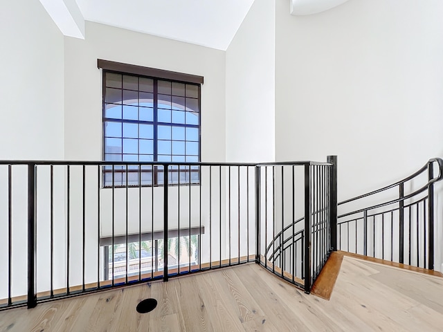 corridor with hardwood / wood-style flooring