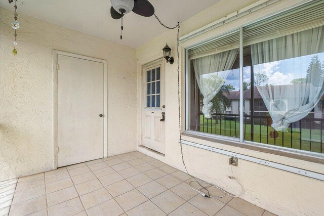 view of exterior entry with ceiling fan