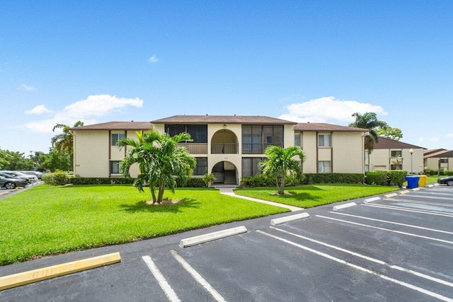 333 Knotty Pine Cir Unit C-2, Greenacres, FL 33463 - view of building exterior featuring uncovered parking
