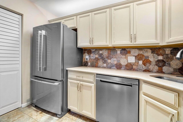 333 Knotty Pine Cir Unit C-2, Greenacres, FL 33463 - kitchen with appliances with stainless steel finishes, cream cabinetry, a sink, and tasteful backsplash