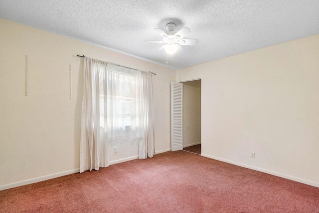 carpeted spare room with ceiling fan and a textured ceiling