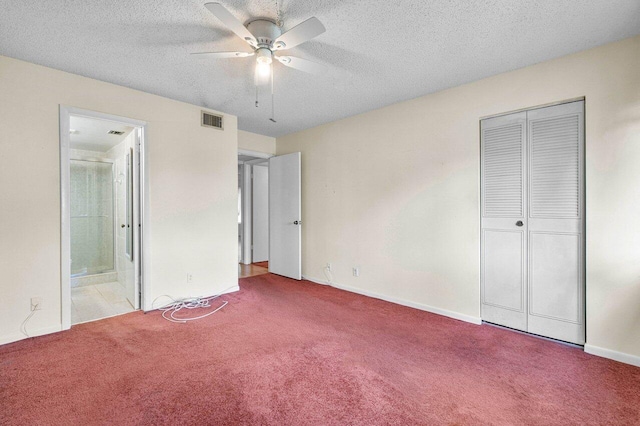 333 Knotty Pine Cir Unit C-2, Greenacres, FL 33463 - unfurnished bedroom with carpet floors, connected bathroom, a textured ceiling, baseboards, and a closet