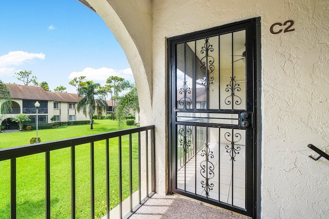 333 Knotty Pine Cir Unit C-2, Greenacres, FL 33463 - entrance to property featuring stucco siding, a balcony, and a yard