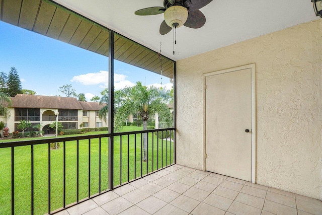 unfurnished sunroom featuring ceiling fan