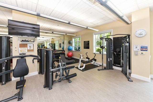 gym with light hardwood / wood-style floors