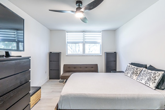 bedroom with ceiling fan and light hardwood / wood-style flooring