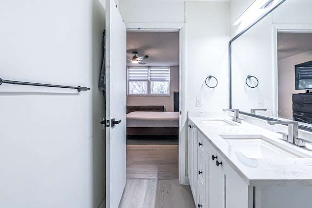 bathroom featuring ceiling fan, vanity, and hardwood / wood-style flooring