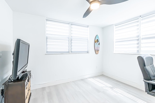 office featuring light hardwood / wood-style flooring, ceiling fan, and a healthy amount of sunlight