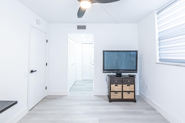 unfurnished bedroom with ceiling fan, light hardwood / wood-style flooring, and a closet