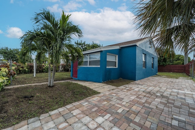 view of home's exterior featuring a yard and a patio