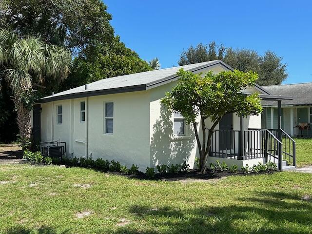 view of home's exterior featuring a yard and central AC unit