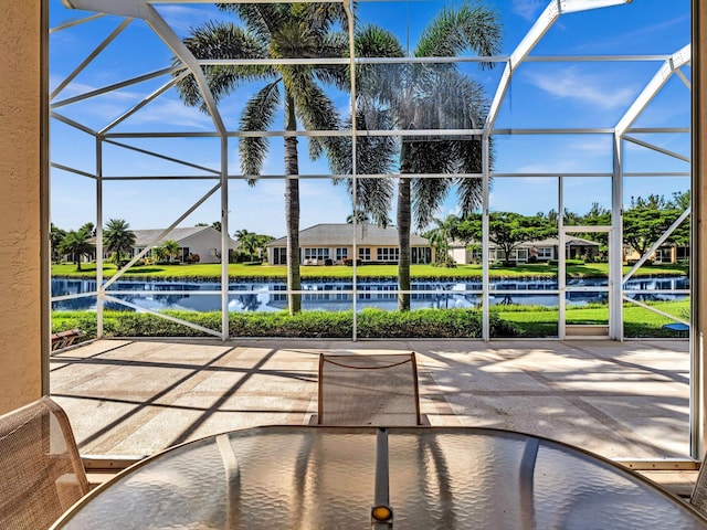 view of swimming pool featuring a lanai, a water view, and a yard