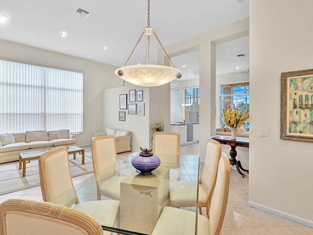 tiled dining room with a healthy amount of sunlight