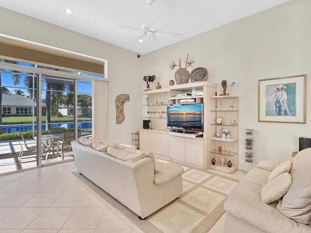 tiled living room featuring a textured ceiling and ceiling fan