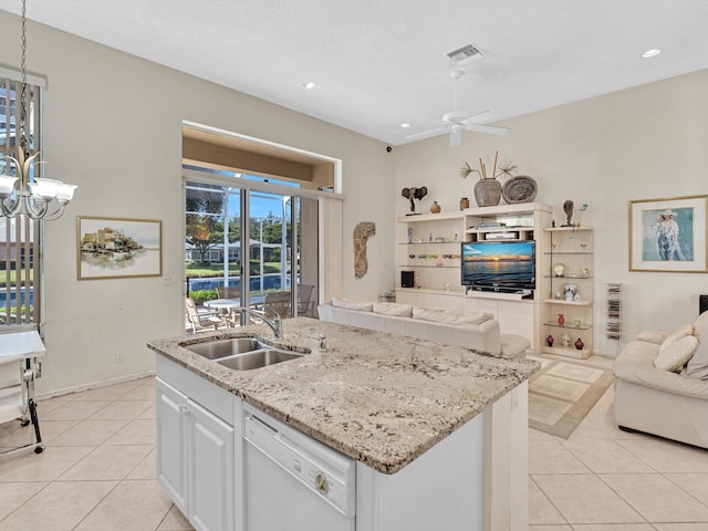 kitchen with white cabinets, white dishwasher, a kitchen island with sink, and sink