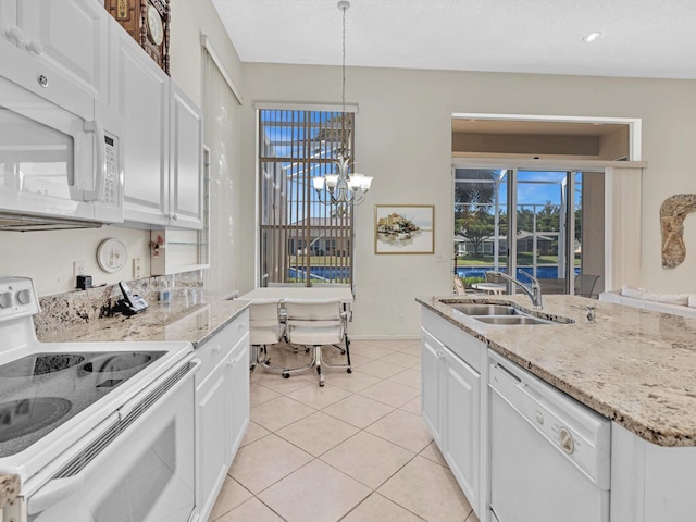 kitchen featuring hanging light fixtures, white appliances, a chandelier, and white cabinets