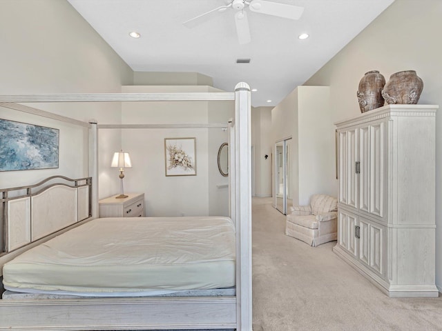 bedroom with ceiling fan, lofted ceiling, and light carpet