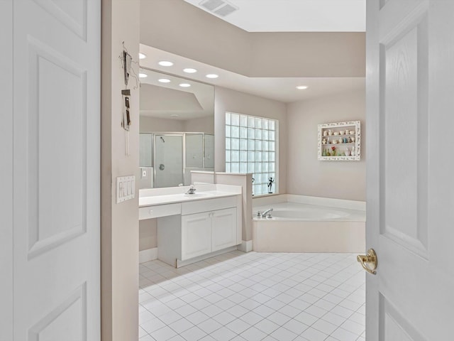 bathroom with independent shower and bath, tile patterned flooring, and vanity