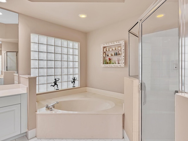 bathroom with vanity, shower with separate bathtub, and tile patterned flooring