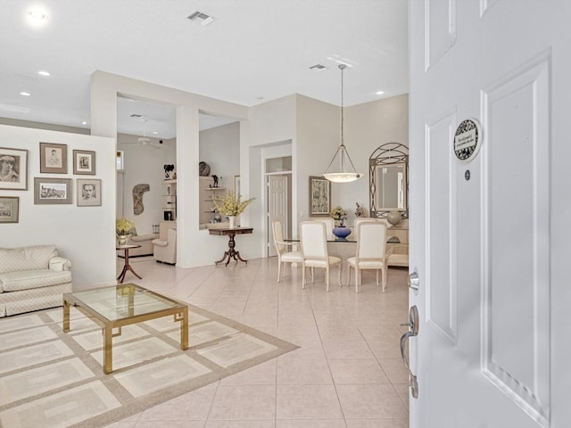 living room with ceiling fan and light tile patterned floors