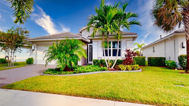 view of front of house with a garage and a front lawn