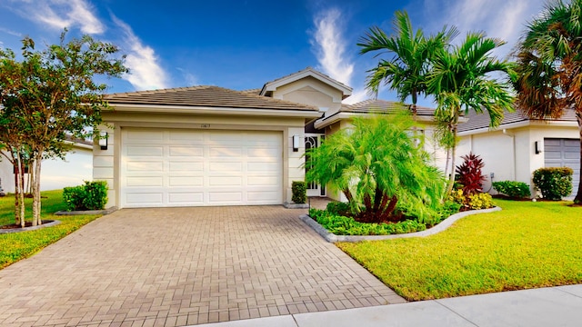 view of front of home with a garage and a front yard