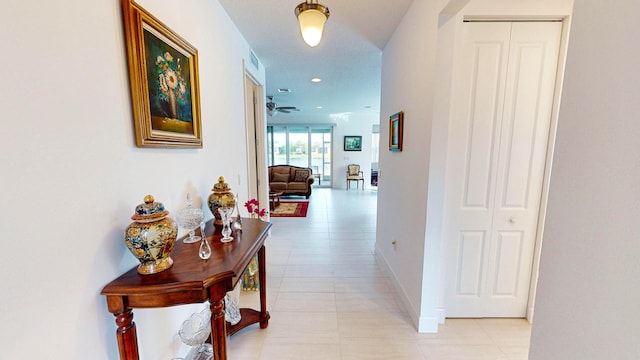 hall featuring light tile patterned floors