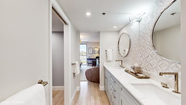 bathroom featuring tasteful backsplash, vanity, and hardwood / wood-style flooring