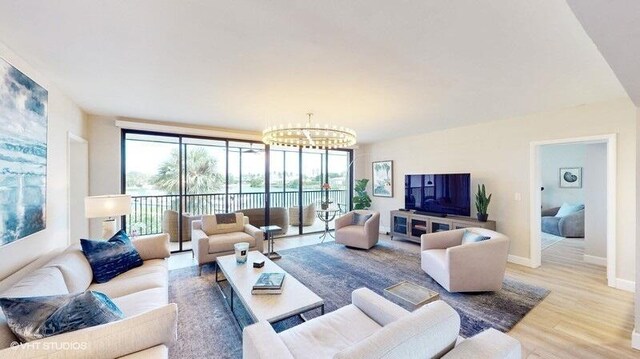 living room featuring wood-type flooring and a chandelier