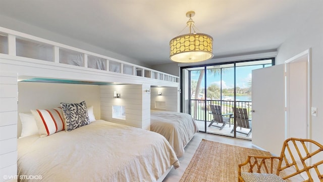 bedroom with a water view and access to outside