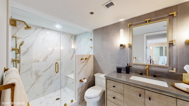 bathroom featuring toilet, an enclosed shower, tile walls, vanity, and decorative backsplash