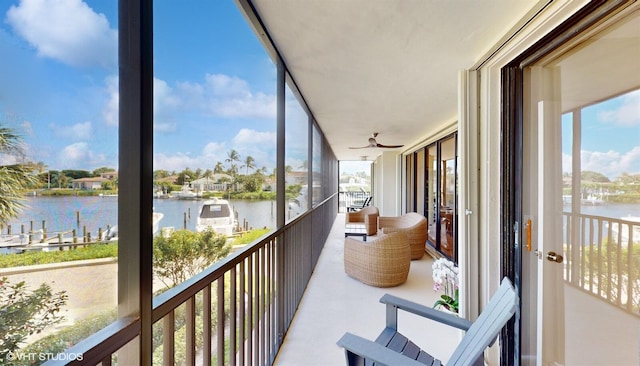 sunroom / solarium featuring a water view