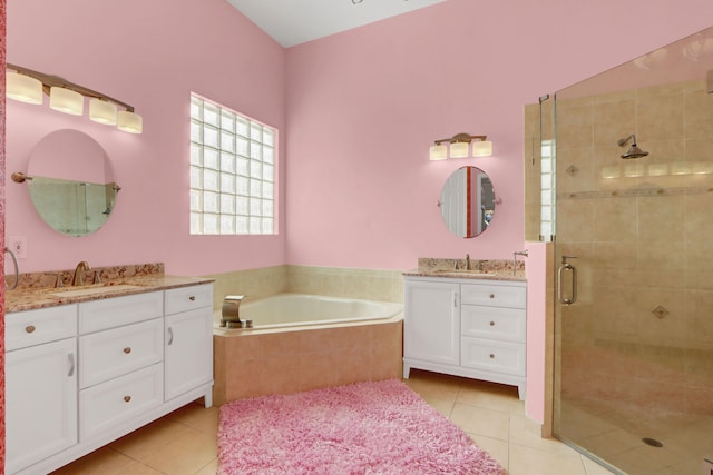 bathroom featuring tile patterned flooring, vanity, and shower with separate bathtub