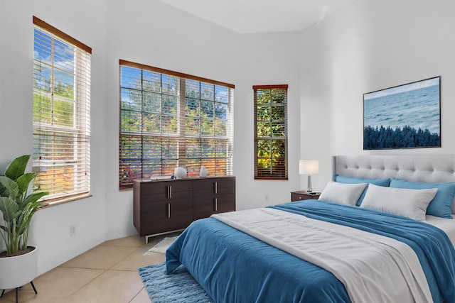 bedroom featuring light tile patterned floors and multiple windows