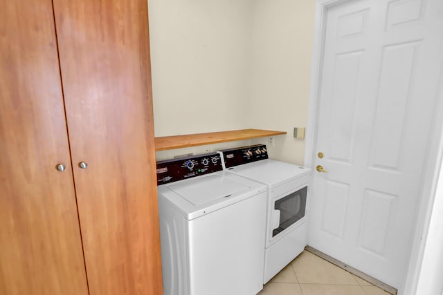 washroom with independent washer and dryer and light tile patterned floors