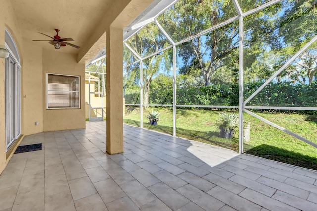 unfurnished sunroom with vaulted ceiling and ceiling fan