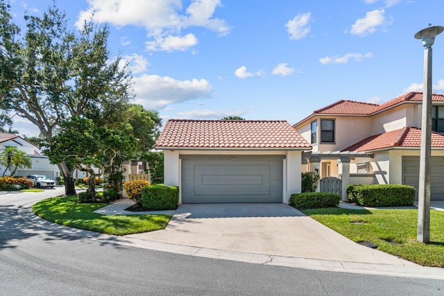 mediterranean / spanish-style home with a front yard and a garage