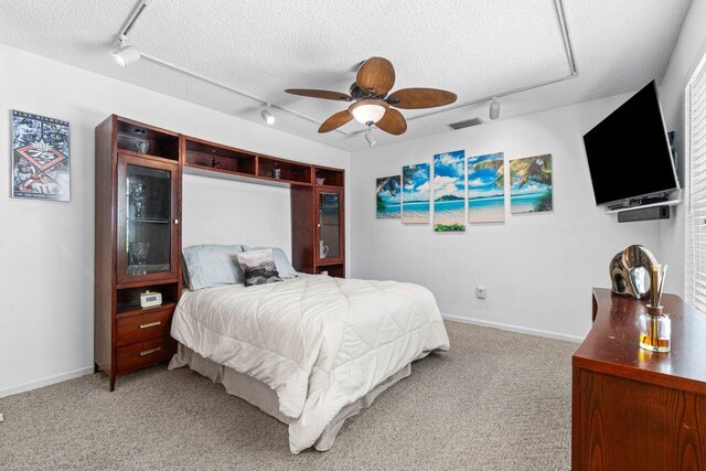 dining room featuring ceiling fan, dark hardwood / wood-style floors, a fireplace, and a textured ceiling