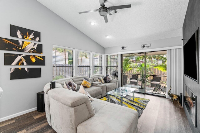 living room with a textured ceiling, dark hardwood / wood-style floors, ceiling fan, and high vaulted ceiling