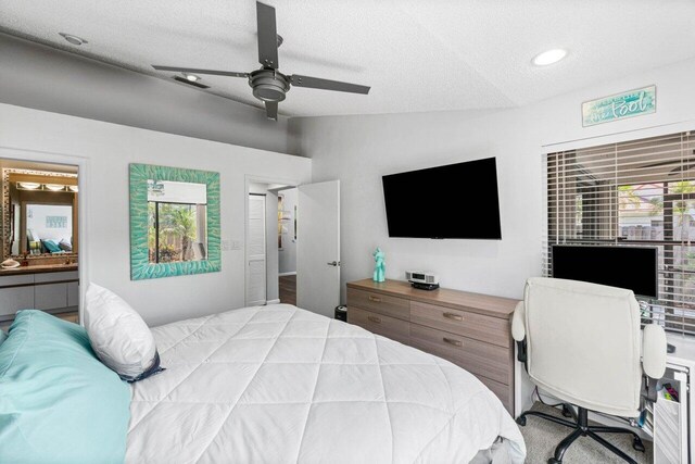 carpeted bedroom featuring ceiling fan, a textured ceiling, and track lighting