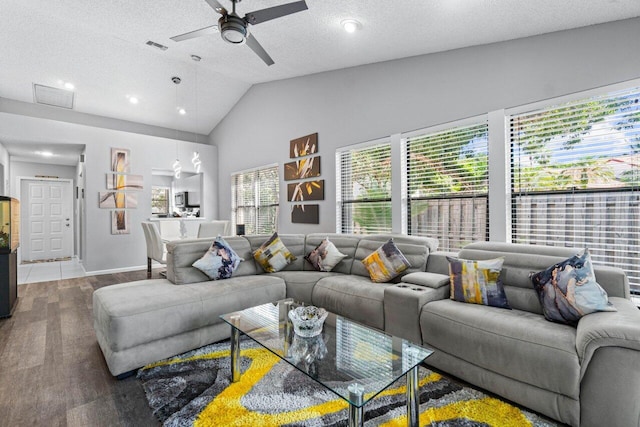 living room with high vaulted ceiling, a textured ceiling, hardwood / wood-style flooring, and ceiling fan