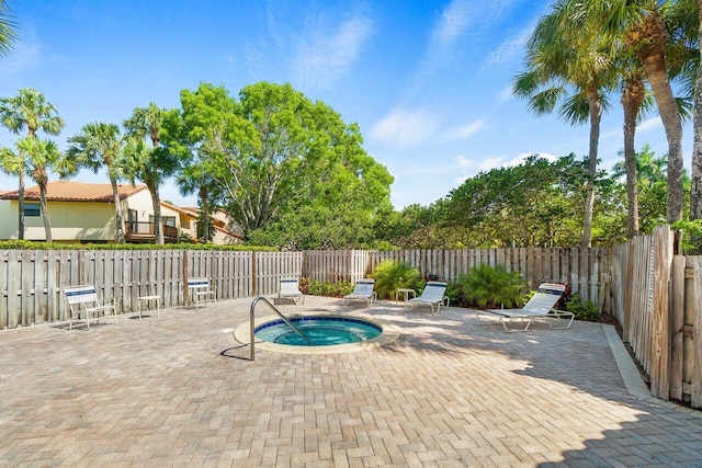 view of swimming pool featuring a community hot tub and a patio area