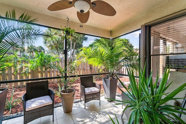 sunroom featuring ceiling fan